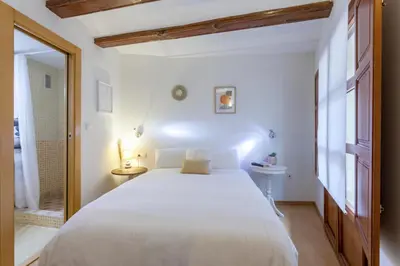 a bedroom with a large white bed and a window at Apartment 1 bedroom Mercado Central in Valencia