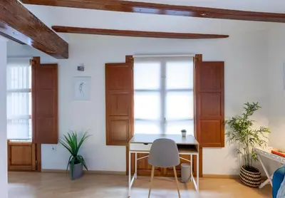 a dining room with a table and two windows at Apartment 1 bedroom Mercado Central in Valencia