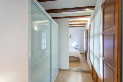 a hallway with a glass door leading to a bedroom at Apartment 1 bedroom Mercado Central in Valencia