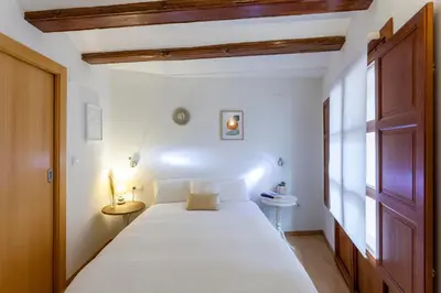 a bedroom with a large white bed and a window at Apartment 1 bedroom Mercado Central in Valencia