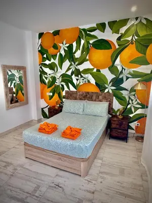 a bedroom with a bed with a mural of oranges at Boutique Loft 1 next to Torres de Serrano in Valencia