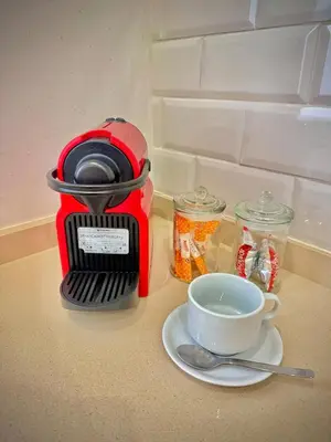 a red coffee maker and a cup on a counter at Boutique Loft 1 next to Torres de Serrano in Valencia