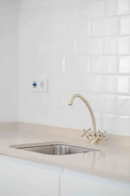 a sink in a kitchen with a white counter top at Boutique Loft 1 next to Torres de Serrano in Valencia