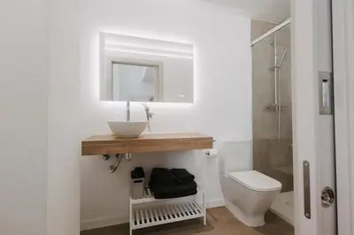 a bathroom with a toilet and a sink and a mirror at Exclusivo loft 3 en zona privilegiada en Valencia in Valencia