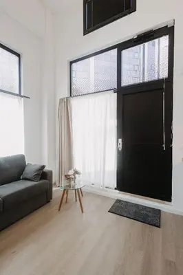 a living room with a couch and a large window at Exclusivo loft 3 en zona privilegiada en Valencia in Valencia