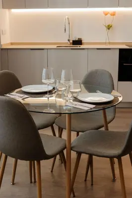 a table with chairs and plates and wine glasses at Luxury apartment in Valencia in Valencia