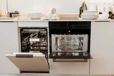 an open dishwasher in a kitchen with dishes in it at Luxury apartment in Valencia in Valencia