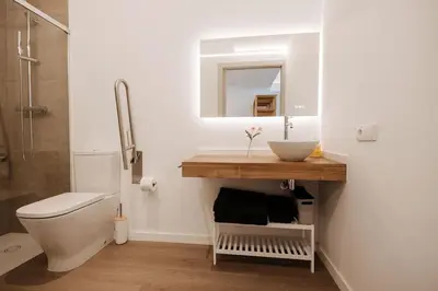 a bathroom with a sink and a toilet and a mirror at Luxury apartment in Valencia in Valencia