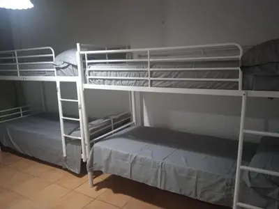 a room with two bunk beds and a room with at Chalet en la naturaleza in Macastre