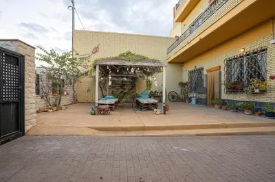 an outdoor patio with a pergola next to a building at Villa Naranjos - Sauna - Jacuzzi - Gym - BBQ in Picassent