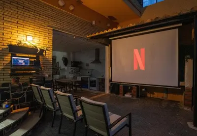 a projector screen with a screen with a letter on it at Villa Naranjos - Sauna - Jacuzzi - Gym - BBQ in Picassent