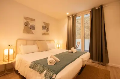 a bedroom with a bed with towels on it at Apartamento Familiar En Valencia Centro - Plaza Ayuntamiento in Valencia