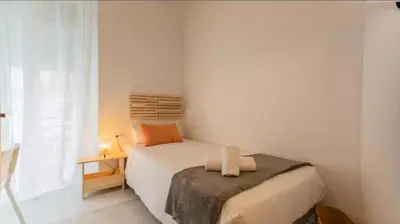 a small bedroom with a bed and a window at Your apartment in the heart of Valencia in Valencia