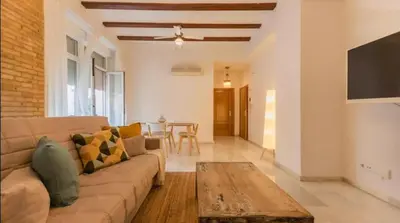 a living room with a couch and a table at Your apartment in the heart of Valencia in Valencia