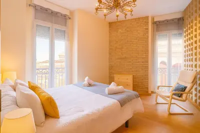 a bedroom with a large bed and a couch at Apartment in the center of Valencia in Valencia