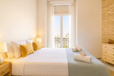 a bedroom with a large white bed with a window at Apartment in the center of Valencia in Valencia