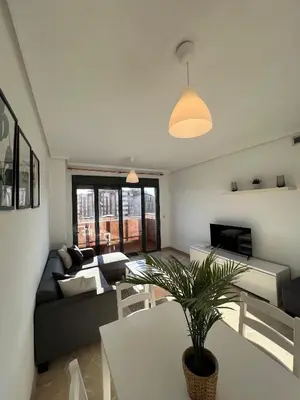 a living room with a couch and a table at Cortes Suite - Pool paddle tennis court and gym in Valencia