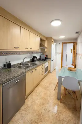 a kitchen with a blue table and a table and a table and chairs at Cortes Suite - Pool paddle tennis court and gym in Valencia