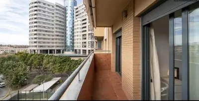 an apartment balcony with a view of a city at Cortes Suite - Pool paddle tennis court and gym in Valencia