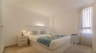 a white bedroom with a white bed and a window at Historic Center - Loft in the heart of Valencia in Valencia