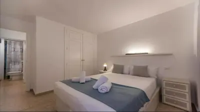 a bedroom with a bed with two towels on it at Historic Center - Loft in the heart of Valencia in Valencia