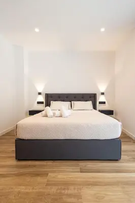 a bedroom with a bed with two pillows on it at Rice Museum Apartments in Valencia