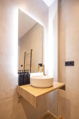 a bathroom with a sink and a mirror at Rice Museum Apartments in Valencia