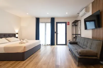 a bedroom with a bed and a couch at Rice Museum Apartments in Valencia