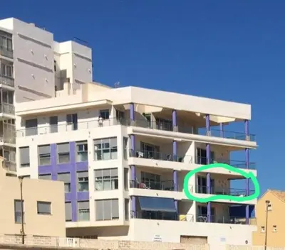 a tall building with a green circle on it at Casa Xalera in Mareny Barraquetas