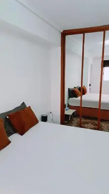 a bedroom with a bed and a mirror at Piso perfecto in Mislata