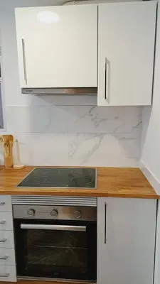 a kitchen with a stove and white cabinets at Piso perfecto in Mislata