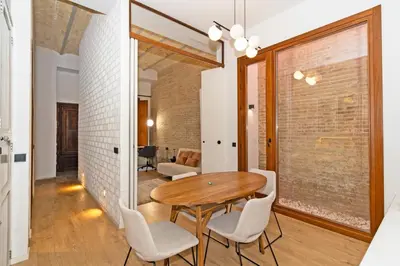a dining room with a wooden table and chairs at Guestready - Bright stay at Cabanyal in Valencia