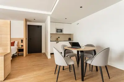 a dining room with a table with chairs and a laptop at B48 Valencia Feria in Valencia