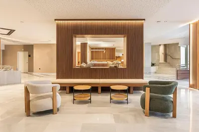 a lobby with a table and chairs and a couch at B48 Valencia Feria in Valencia