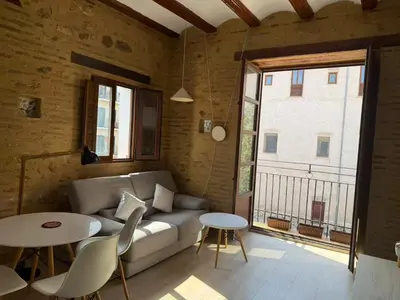 a living room with a couch and tables and a window at Precioso Loft en la Ciutat Vella en Valencia in Valencia