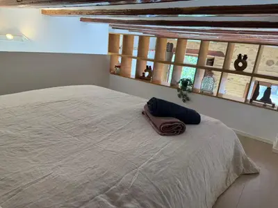 a bedroom with a large bed with a towel on it at Precioso Loft en la Ciutat Vella en Valencia in Valencia
