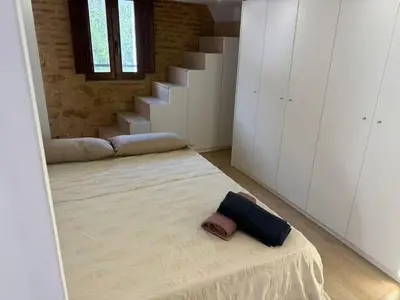 a room with a large bed with a staircase at Precioso Loft en la Ciutat Vella en Valencia in Valencia