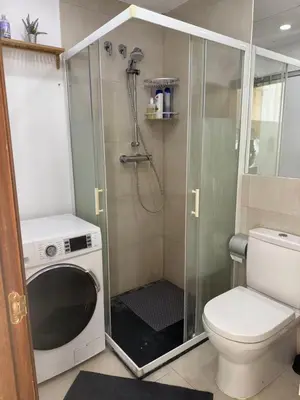 a bathroom with a shower and a toilet and a washing machine at Precioso Loft en la Ciutat Vella en Valencia in Valencia