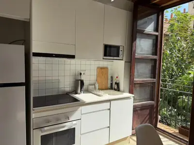 a white kitchen with a sink and a microwave at Precioso Loft en la Ciutat Vella en Valencia in Valencia