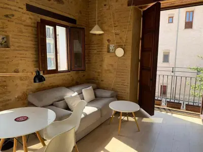 a living room with a couch and two tables at Precioso Loft en la Ciutat Vella en Valencia in Valencia