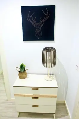 a white dresser with a lamp and a cactus at Ubicación ideal, entre la playa y el centro ciudad in Valencia
