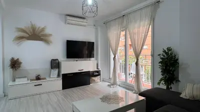 a living room with a flat screen tv on a wall at Ubicación ideal, entre la playa y el centro ciudad in Valencia