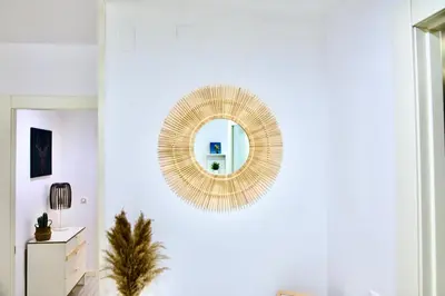 a living room with a mirror on the wall at Ubicación ideal, entre la playa y el centro ciudad in Valencia