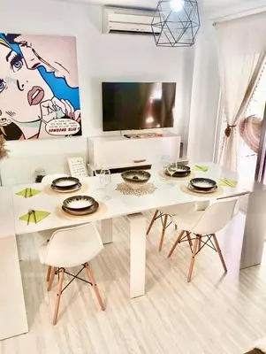 a white dining room with a white table and chairs at Ubicación ideal, entre la playa y el centro ciudad in Valencia