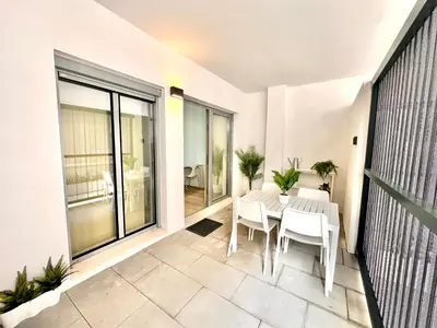 a patio with a table and chairs on a balcony at Turia view apartment in Valencia