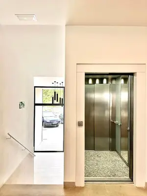 a glass elevator door with a car in a parking lot at Turia view apartment in Valencia