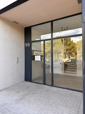 a glass door of a building with a car outside at Turia view apartment in Valencia