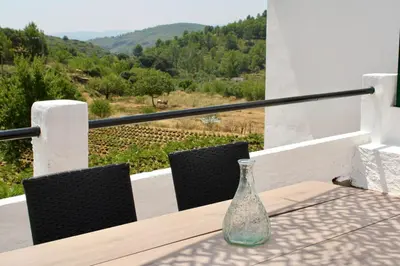 a glass bottle sitting on top of a wooden table at Estudio Finca Mas el Bravo in Caudiel