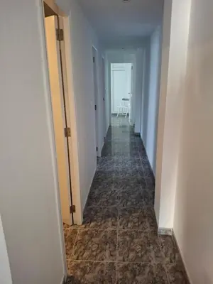 an empty hallway with a long corridor with white walls at Sea and Sun con vistas a la playa San Antoni in Cullera