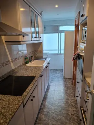 a kitchen with a sink and a refrigerator at Sea and Sun con vistas a la playa San Antoni in Cullera